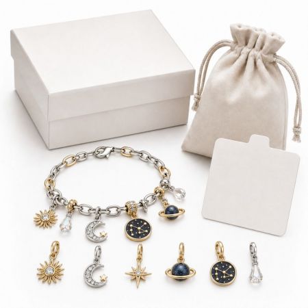 Celestial charm bracelet featuring gold moon, stars, and planet charms, displayed with white packaging options.
