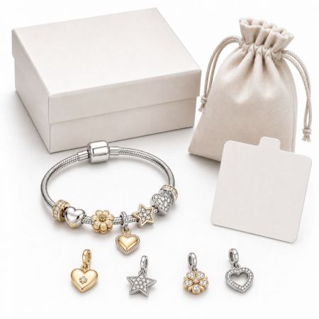 Custom gold and silver heart charm bracelet with flower and star charms, featuring elegant gift box packaging.