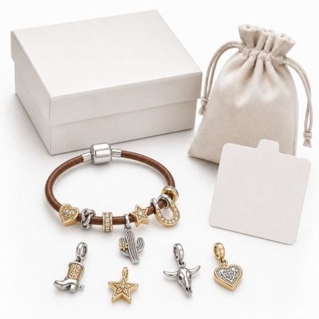Western style leather charm bracelet with cactus and cowboy boot charms, displayed next to retail gift boxes.