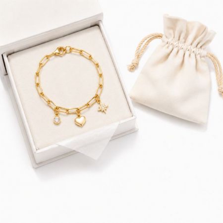 Gold star and heart link bracelet displayed in a white jewelry box, premium quality for wholesale jewelry buyers.