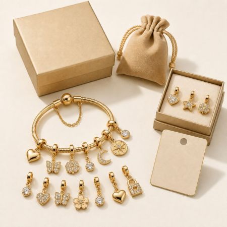 Custom gold charm bracelet featuring mixed celestial and floral pendants, arranged with premium jewelry packaging.
