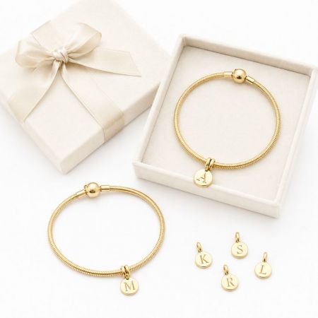 Gold snake chain charm bracelets and custom round initial discs, tailored for fashion accessory suppliers.