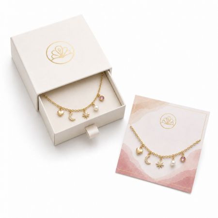 Delicate gold chain anklet or bracelet with celestial pendants, packaged in a luxury drawer-style wholesale box.