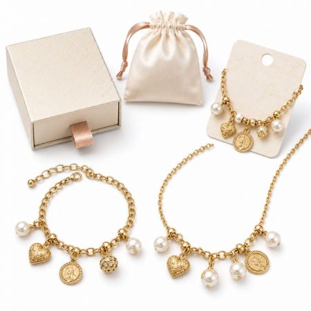 Gold coin and pearl dangle bracelet and necklace collection, shown with custom B2B packaging options.