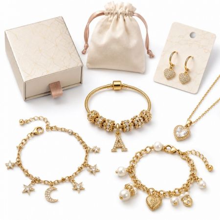 Assorted gold rhinestone charm bracelets and heart pendant, displayed with custom retail display cards.