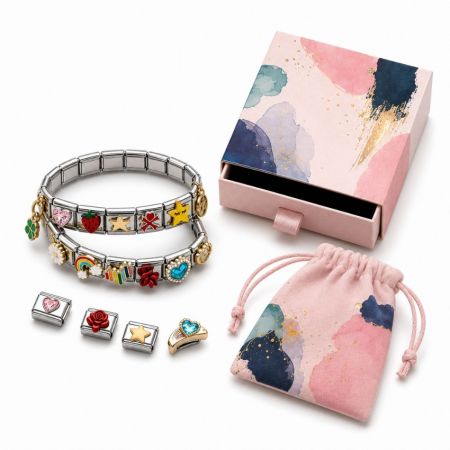 Stainless steel Italian modular charm bracelets with colorful enamel charms, presented next to a luxury gift box.