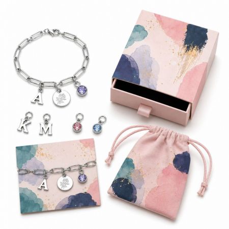 Silver personalized initial charm bracelet with engraved round tag and birthstone, ideal for custom jewelry brands.