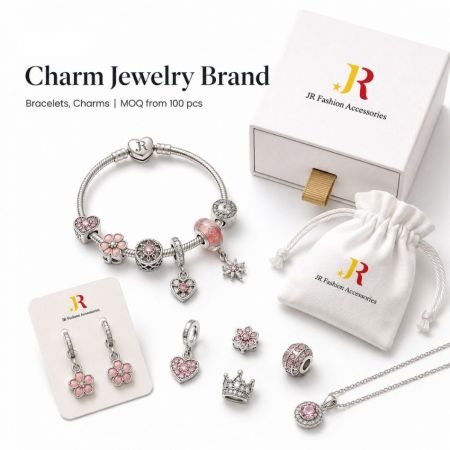 Silver charm bracelet with pink crystals and floral beads beside branded jewelry box and pouch, low MOQ wholesales.