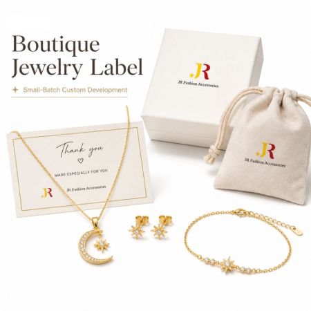 Gold celestial moon and star jewelry set featuring a necklace, earrings, and bracelet with custom branded packaging.