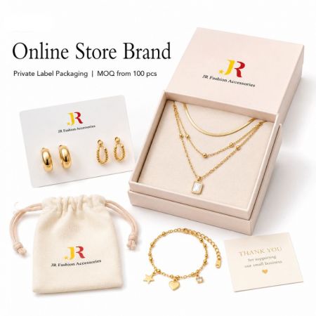 Gold layered necklace in a private label box, displayed with matching hoop earrings, star bracelet, and canvas pouch.