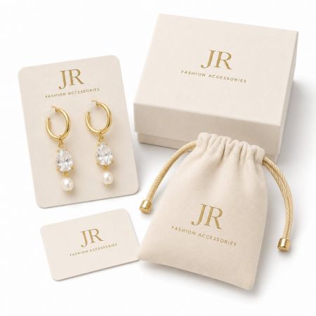 Gold pearl and CZ drop earrings on custom display card with pouch. B2B wholesale jewelry supplier.