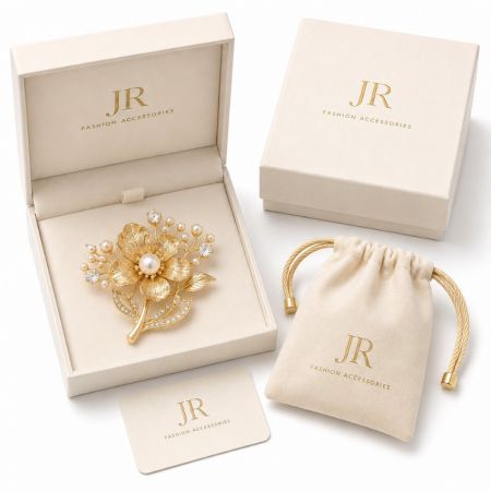 Gold floral pearl brooch in custom branded packaging box. JR Fashion Accessories B2B jewelry wholesale.