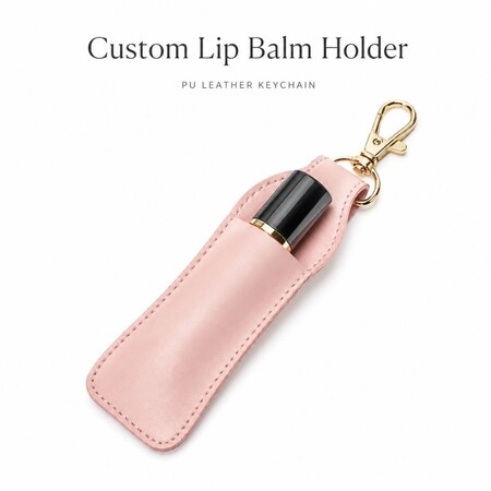 Custom pink PU leather lip balm holder keychain with gold clasp, ideal B2B promotional gift for cosmetics brands.