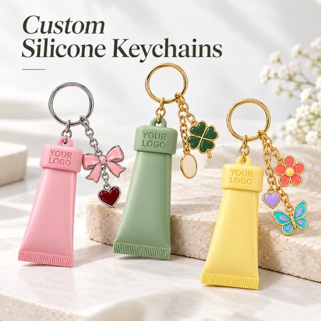Custom Silicone Keychains with Metal Charms - Custom silicone squeeze tube keychains with enamel charms and keyrings for cosmetics brand wholesale.
