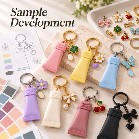 Sample development process of custom silicone tube keychains with color swatches and assorted charms.