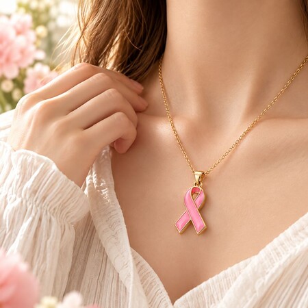 Model wearing gold pink enamel ribbon necklace, ideal for breast cancer awareness jewelry wholesale.