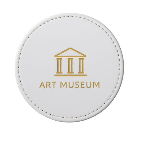 Custom Leather Coasters - A custom brown leather coaster featuring the debossed logo of an art museum, showcasing a premium promotional gift option.