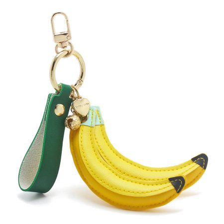 A variant of the banana keychain featuring a green leather strap and gold charms for a unique look.