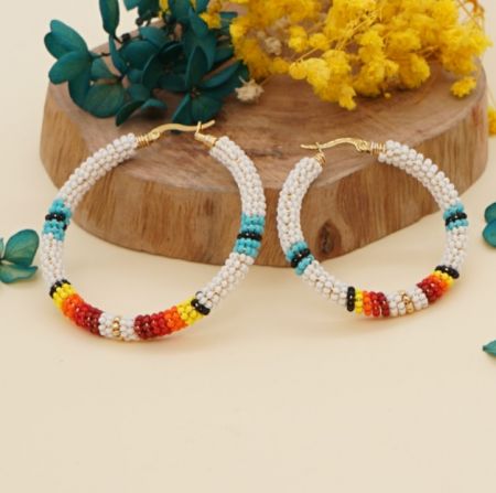 Close-up detail of the colorful Miyuki beads on the gold hoop earrings.