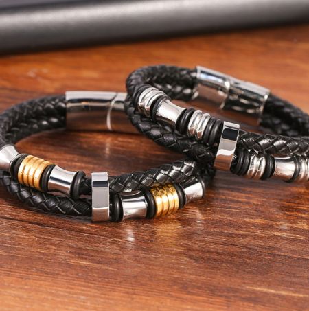 Two variations of the men's leather bracelet, one with silver and one with gold and silver metal details.