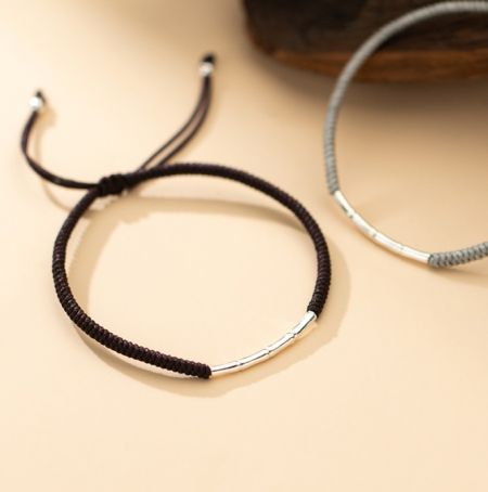 Close-up view of the 925 Sterling Silver Bamboo Rope Bracelet in dark brown and light gray, highlighting the silver accents and cord texture.
