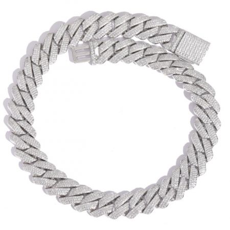 A braided silver Cuban link bracelet fully set with shimmering stones.