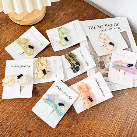 Acetate Cat-Shaped Hair Clips with Fish Bone and Pearl Accents - A collection of colorful cat-shaped acetate hair clips with pearl details, displayed on 'Fashion Jewelry' cards, showcasing the variety available in the 5-piece set.