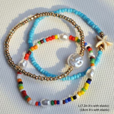 A vibrant set of four bohemian-style beaded bracelets, featuring gold, blue, and multicolored beads with a delicate starfish charm.