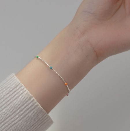 Model wearing the 925 sterling silver beaded bracelet to showcase its fit and style on the wrist.