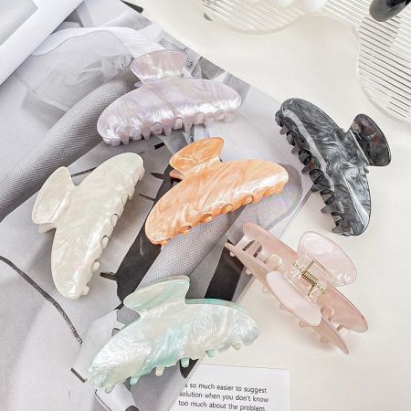An assortment of colorful claw hair clips arranged neatly.