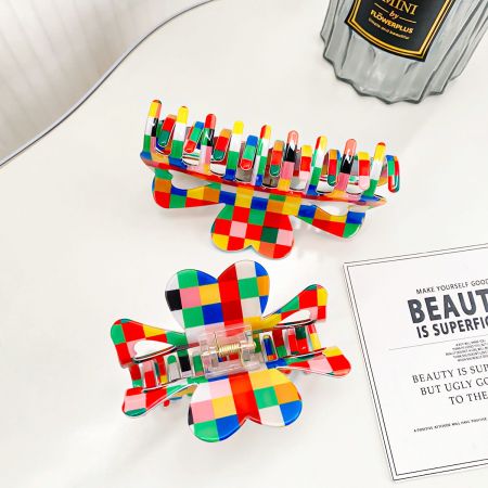 Two vibrant, checkered pattern hair clips showcased against a white background.