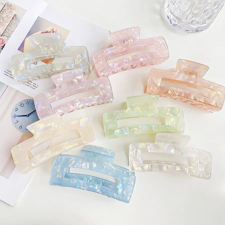 Wholesale Colorful Acetate Big Claw Hair Clips - A vibrant collection of wholesale colorful acetate big claw hair clips in various shades, neatly arranged for display.