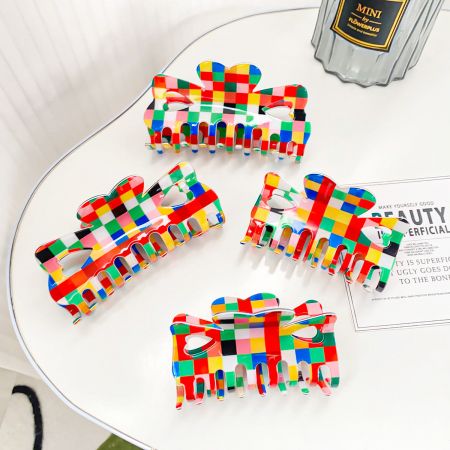 A collection of colorful checkered hair clips arranged neatly on a table for display.