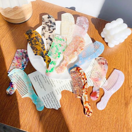 Portable Plastic Acetate Handle Hair Combs - A vibrant collection of portable acetate hair combs in various marbled colors and patterns, displayed on a white surface.