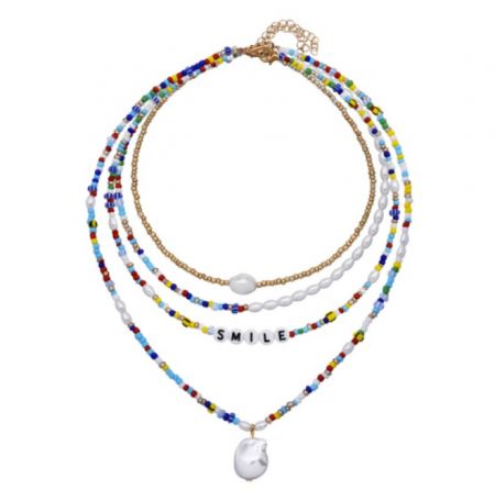 Close-up of the colorful layered Rainbow Handmade Beads Necklace, detailing the 'SMILE' pendant and teardrop charm.
