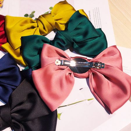 An assortment of colorful satin hair bows, perfect for wholesale collections.