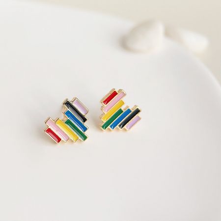 A pair of colorful, striped heart earrings from the set on a clean white background.