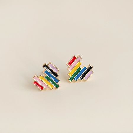 A detailed view of the colorful enamel work on the gold-plated heart earrings.