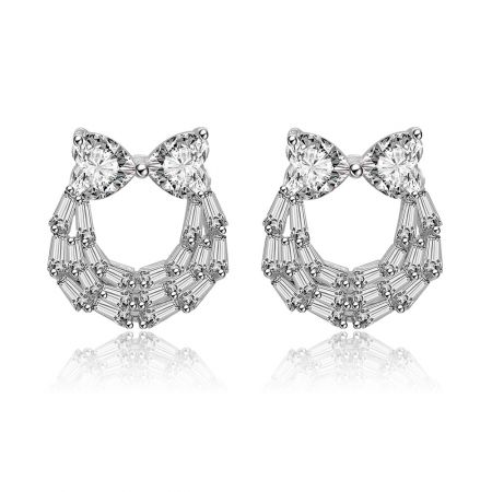 Two Hearts And Baguette Earrings - Front view of the Two Hearts And Baguette Earrings, showcasing the rhodium-plated brass setting with a heart-shaped cubic zirconia and a bow-like crystal frame.