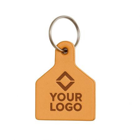 A custom-shaped leather keychain featuring a detailed logo, showcasing versatile branding possibilities.