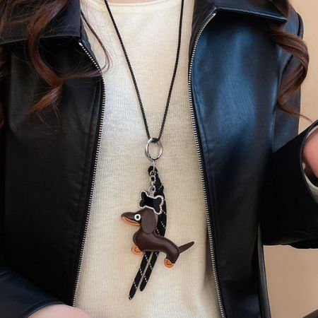 Close-up of a charming dachshund pendant brass necklace.
