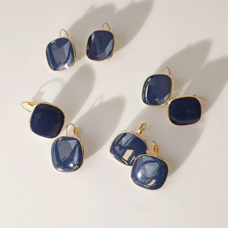 Collection display of the navy blue and gold square hoop earrings.