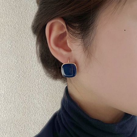 Model wearing the vintage navy blue enamel square hoop earrings.