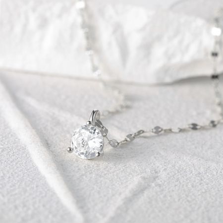 Angled shot of the sparkling single stone pendant on the silver chain.