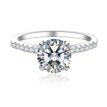 Round CZ Engagement Ring - A stunning Round CZ Engagement Ring featuring a large round-cut cubic zirconia centerpiece in a four-prong setting on a rhodium-plated brass band with side stone accents.