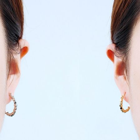 A model showcasing two different styles of the beaded hoop earrings.