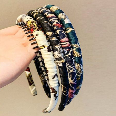 Assortment of fabric-wrapped headbands in various stylish patterns and colors.