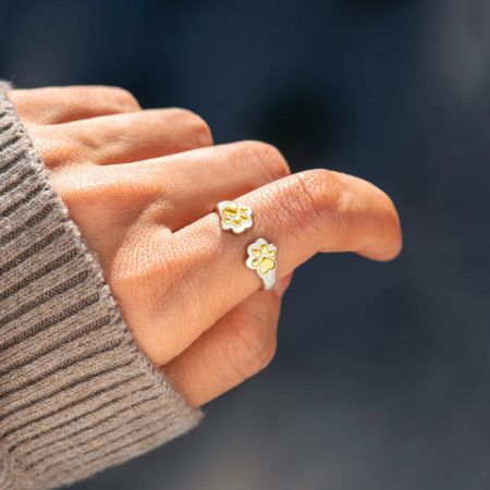 A model wearing the cute silver and gold dog paw print ring, a great accessory for pet moms.
