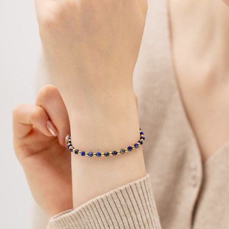 A vibrant blue and gold beaded bracelet adding a pop of color to the wrist.