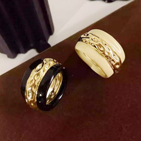 Detailed shot of the two-tone enamel rings showcasing their gold and colored bands.